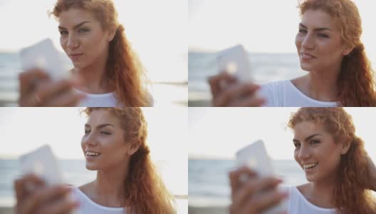 在海滩上用智能手机自拍的快乐女人高清在线视频素材下载