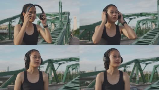亚洲女运动员通过耳机听音乐高清在线视频素材下载