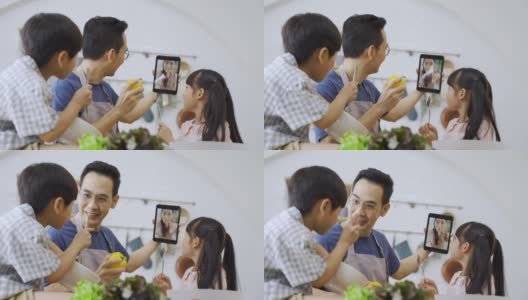 亚洲的父亲和孩子们在电子平板电脑上与妈妈进行视频通话。高清在线视频素材下载