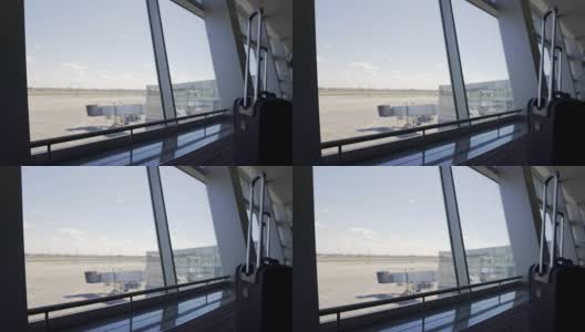 通过航站楼窗口，登机口和机场空跑道，交通高清在线视频素材下载