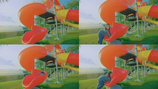 Happy Child Playing On A Slide At The Playground高清在线视频素材下载