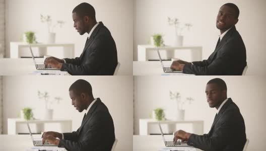非裔美国商人坐在办公桌前用电脑工作高清在线视频素材下载