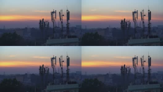 傍晚/日出时，城市景观和黄色天空建筑顶部的天线。高清在线视频素材下载