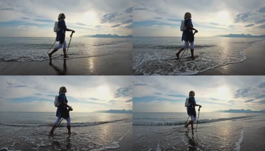 在海滩上散步的北欧老年妇女高清在线视频素材下载
