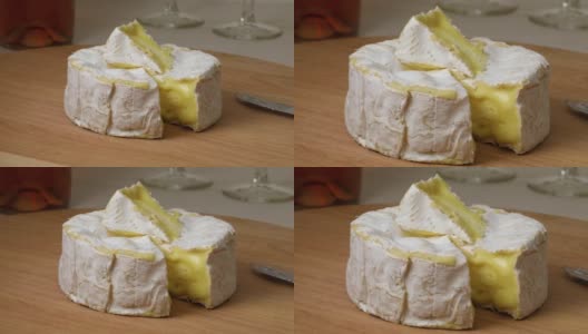 成熟的卡芒贝尔奶酪和一块特写高清在线视频素材下载