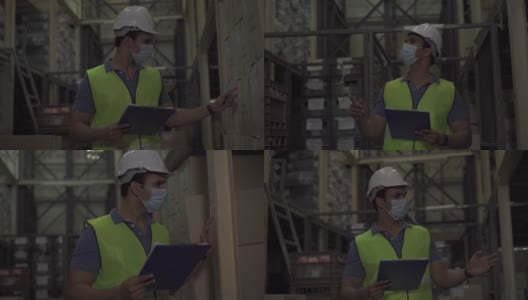 年轻的印度工厂仓库工人戴着防护面罩和安全帽在物流行业室内工作。30多名男子在检查新冠肺炎大流行期间的库存订单高清在线视频素材下载