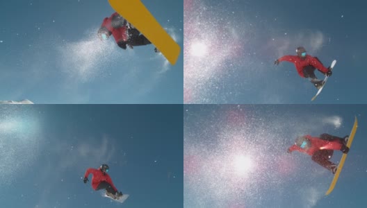 从下往上:当滑雪者在做滑雪特技时，雪花在阳光下闪闪发光。高清在线视频素材下载