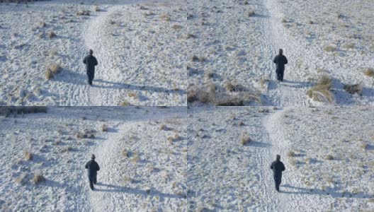 在苏格兰西南部，一位老人独自走在积雪覆盖的人行道上高清在线视频素材下载