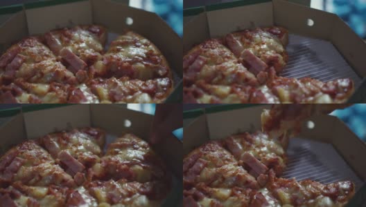 纸盒子上的披萨火腿奶酪特写。高清在线视频素材下载
