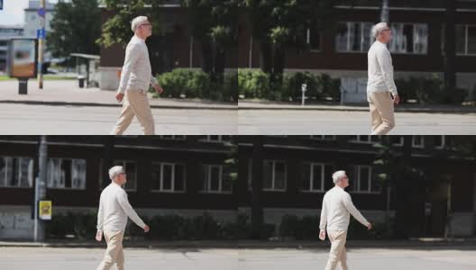 老人走在夏季城市的街道上高清在线视频素材下载