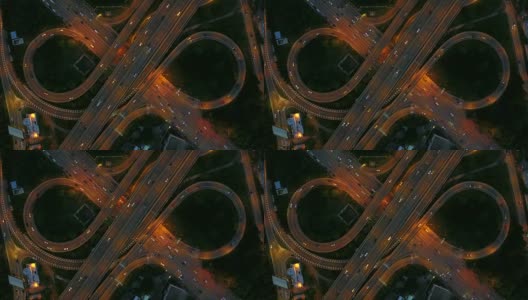 无限高速公路立交桥鸟瞰图，繁忙的城市交通在夜间高速行驶高清在线视频素材下载