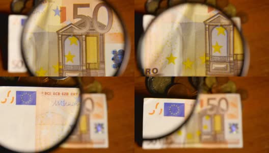 放大镜上的欧元纸币高清在线视频素材下载