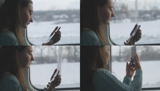 小女孩在火车上旅行，用手机拍下窗外的风景。美女用智能手机拍照。近距离高清在线视频素材下载