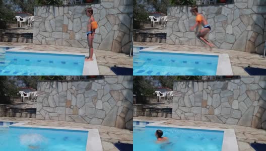 男孩在游泳池里跳着，手持式射击高清在线视频素材下载