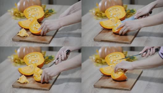 女人在厨房的木制桌子上清理南瓜。男正准备切桔黄色的南瓜片。高清在线视频素材下载