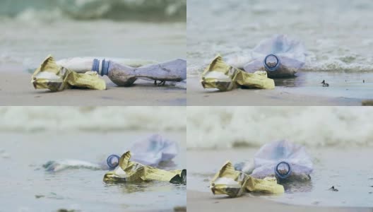 塑料瓶和旅游船上的垃圾在海岸被污染的水冲洗高清在线视频素材下载