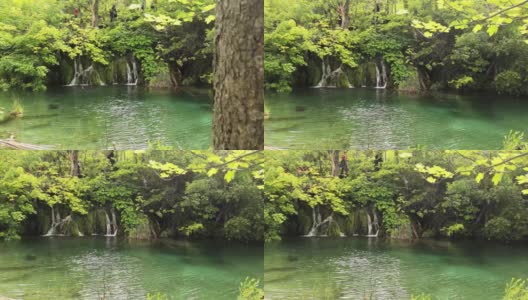 平移运动显示一个小美丽宁静的瀑布在克罗地亚普利特维茨湖自然公园。新冠肺炎疫情爆发后，公园在温暖的夏日开放，绿意盎然高清在线视频素材下载