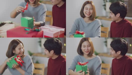 快乐的亚洲夫妇与视频通话，同时使用笔记本电脑和打开圣诞礼盒高清在线视频素材下载