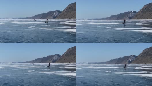 一群游客在结冰的贝加尔湖上溜冰。高清在线视频素材下载