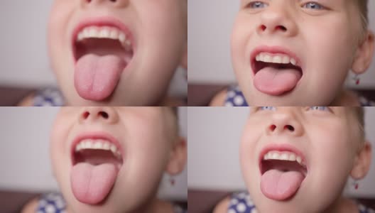 女孩张大嘴巴，伸出长长的舌头。孩子露出了他的牙齿高清在线视频素材下载