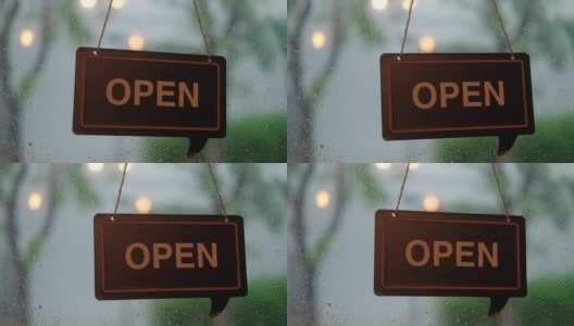 咖啡馆门上的欢迎开门标志，以雨为背景。高清在线视频素材下载