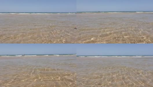 从阳光下看到的浅水沙滩上的海水高清在线视频素材下载