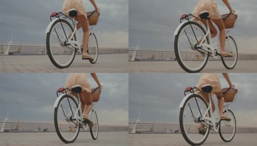 户外肖像女性的腿骑她的嬉皮复古自行车在复古时尚的裙子。享受夏日，在港口摆好姿势。休闲的生活方式。慢动作高清在线视频素材下载