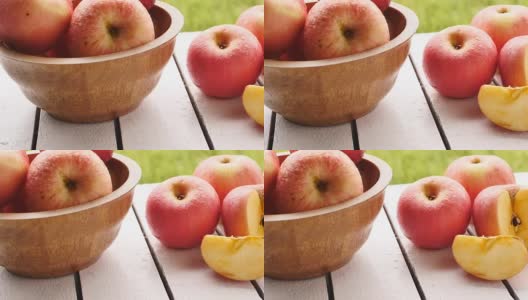 以自然为背景的木桌上的红苹果高清在线视频素材下载