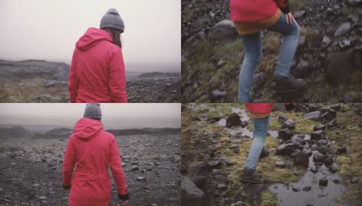 年轻女子徒步在岩石山的后视图。独自探索冰岛的旅行女性，徒步穿越沼泽高清在线视频素材下载