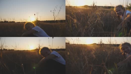 日落时分，一个欢快的小女孩坐在草地上看着照相机。快乐的小孩在夏日的草地上休息时笑。自由自在的概念。多莉拍摄高清在线视频素材下载