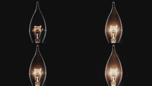 烛光形状的爱迪生灯闪烁在黑色，宏观的观点高清在线视频素材下载
