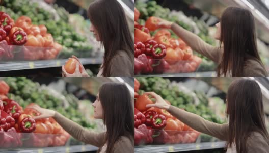 年轻女子在商店货架上选择红辣椒高清在线视频素材下载