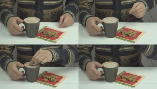男人的手把姜饼蘸可可高清在线视频素材下载