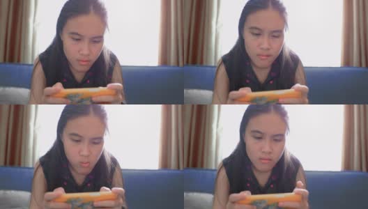 亚洲女孩玩智能手机游戏高清在线视频素材下载