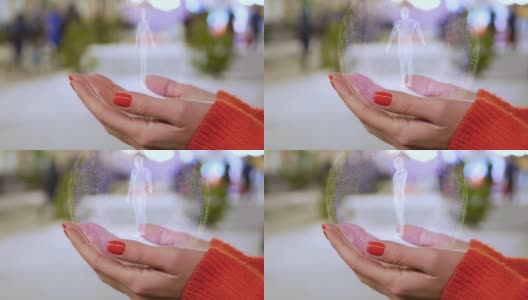 女性的手拿着身体粒子的全息图高清在线视频素材下载