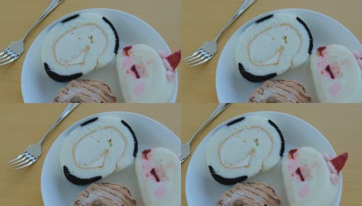 草莓奶油瑞士卷和栗子蛋糕跟踪镜头高清在线视频素材下载