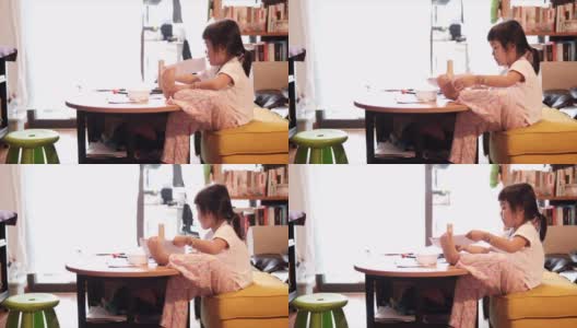 一个亚洲女孩在家画画高清在线视频素材下载