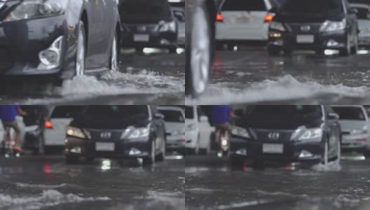 在道路上行驶的汽车带有地表水。交通雨水和道路积水。高清在线视频素材下载
