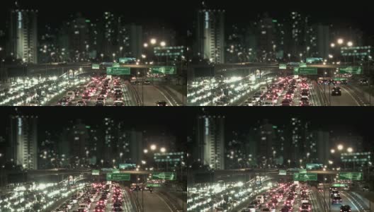 夜间城市交通与散焦建筑的背景高清在线视频素材下载