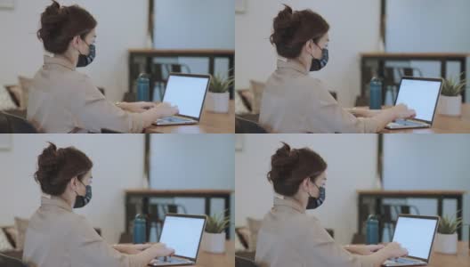 亚洲女商人戴着口罩在笔记本电脑上工作高清在线视频素材下载