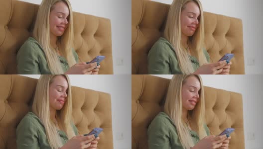 美丽的白色金发女人打字短信手机messenger应用程序与幸福的微笑。视频剪辑漂亮的白人女性使用现代智能手机进行在线交流高清在线视频素材下载