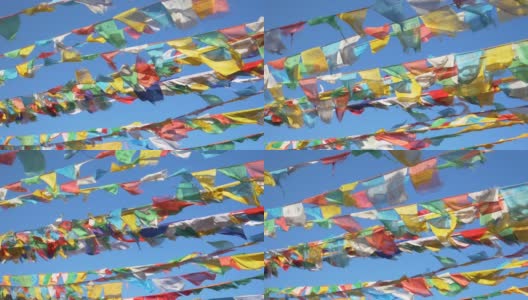 特写:在一个阳光明媚的日子里，电影镜头拍摄了西藏上空飘扬的旗帜高清在线视频素材下载