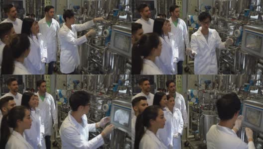 化工厂的工程师学生在他解释罐体和控制板的过程时注意大学伙伴高清在线视频素材下载