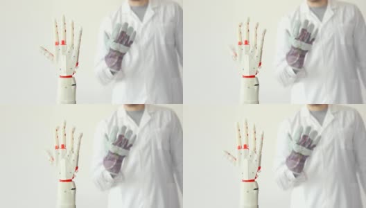 科学家正在测试机器人假肢手，通过传感器重复他的手在手套里的运动。肌肉神经移植技术高清在线视频素材下载