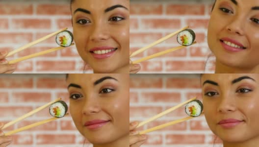 亚洲女人拿着寿司的特写高清在线视频素材下载