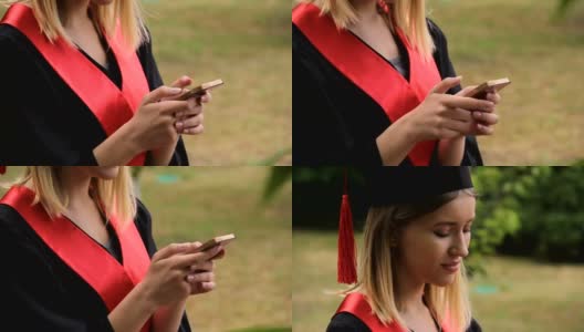 毕业典礼后用智能手机发短信的漂亮金发毕业生高清在线视频素材下载