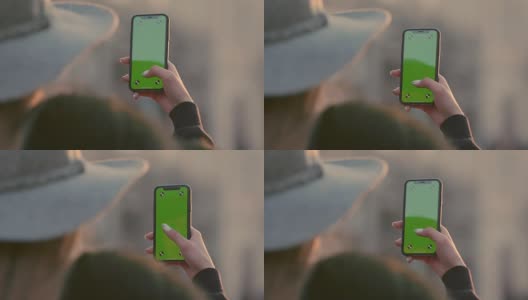 一名女子手持绿屏智能手机，挡住交通高清在线视频素材下载