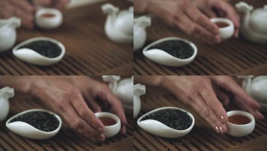 传统的中国茶道。女性手套中国茶杯特写高清在线视频素材下载