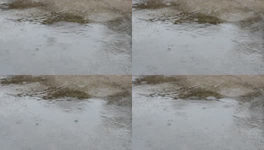 雨滴。雨水落在地板水泥上。大雨滴高清在线视频素材下载