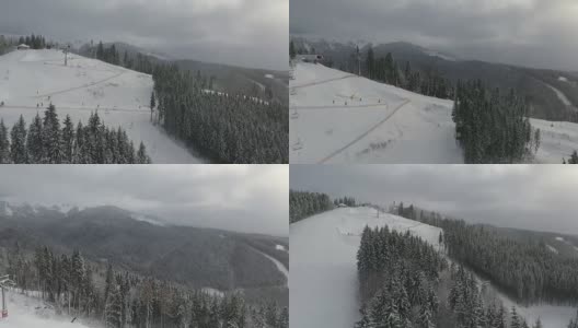 滑雪者和滑雪板运动员从滑雪场的斜坡上滑下来。高清在线视频素材下载